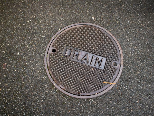Blocked outside drain being cleared at a Brentwood property